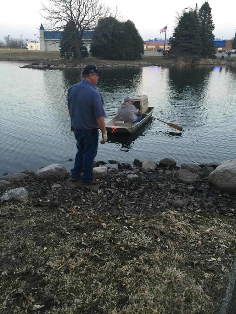 Workers and deputy's paddle to a small island to rescue a dog